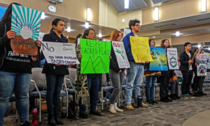 Tribal mmbers and students hold signs in support of a resolution to protect Juristac in Morgan Hill in January 2020