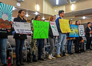 Tribal mmbers and students hold signs in support of a resolution to protect Juristac in Morgan Hill in January 2020